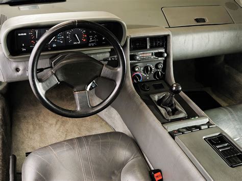 an interior view of a car with the steering wheel and dash board showing, it appears to be in ...