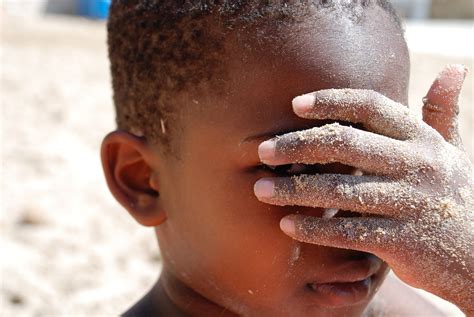 Child Covering His Face with Sandy Hand · Free Stock Photo