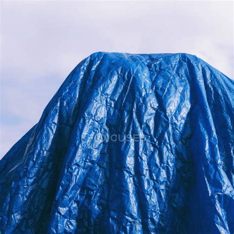 Blue tarpaulin draped against blue sky, cropped. — daylight, bright - Stock Photo | #192123862