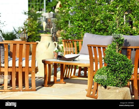 Garden terrace with wooden furniture and plants Stock Photo - Alamy