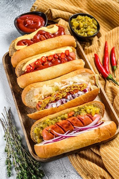 Premium Photo | Hot dogs fully loaded with assorted toppings on a tray