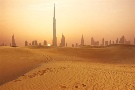 Dubai city skyline at sunset seen from the desert - Pure Vacations