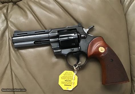 COLT PYTHON 357 MAGNUM, 4” BLUE, MFG. 1969, AS NEW COND.,COMES WITH TEST TARGET, OWNERS MANUAL ...