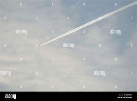 airplane in the sky with clouds Stock Photo - Alamy