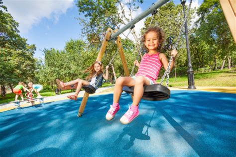 Kids Swing On Playground Stock Photo - Download Image Now - iStock