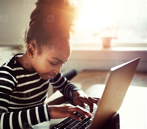 young girl typing on a laptop stock photo (141158) - YouWorkForThem