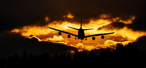 Silhouette of plane flying in the sky during orange sunset HD wallpaper | Wallpaper Flare