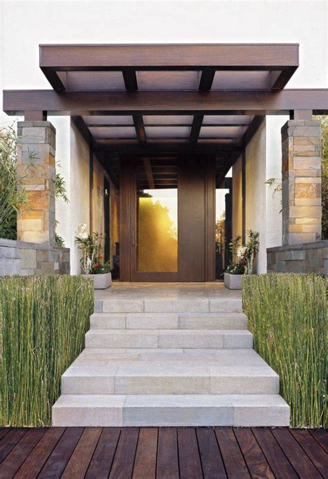 an entry way with steps leading up to the door and grass growing on the ...