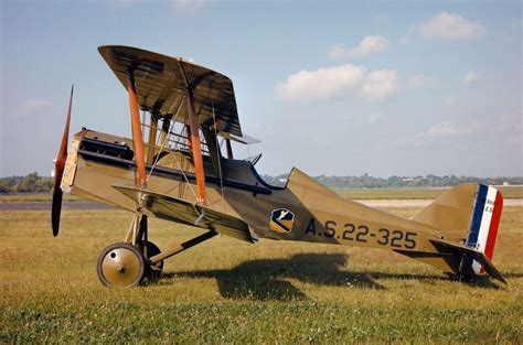 an old airplane sitting on top of a grass covered field