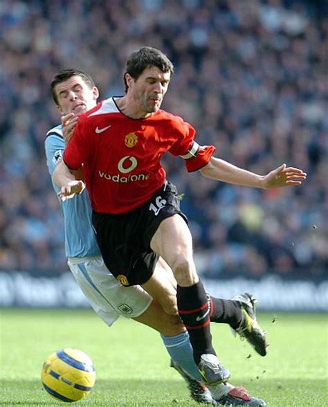 Manchester United's Roy Keane (R) fights for the ball with Manchester City's Joey Barton during ...