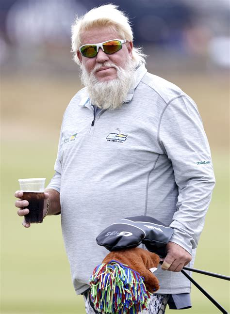 John Daly puffs on a cigarette while practicing for The Open after ...