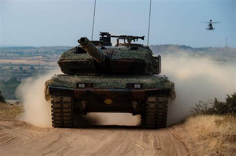 A Hellenic Army Leopard 2AHEL battle tank and a Hellenic Army Aviation ...