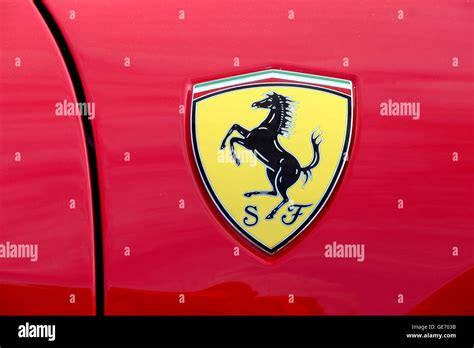 a close up of a Ferrari badge on a red Ferrari car Stock Photo - Alamy