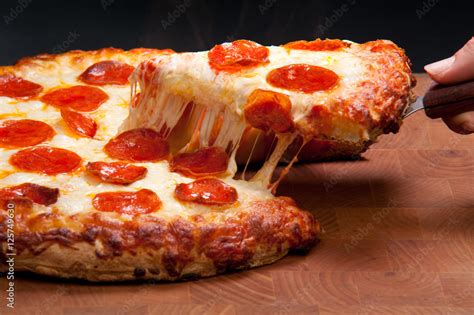 Pepperoni Pizza Cheese Pull - Food Photography foto de Stock | Adobe Stock