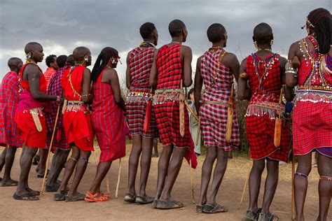 Masai in traditional colorful clothing showing Maasai jumping dance at ...