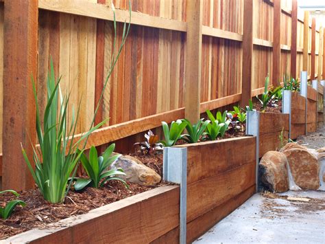 Timber retaining wall on boundary fence. This is going to look great once the plants are ...