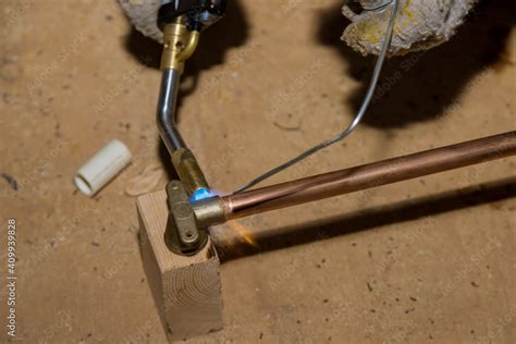 Soldering brass fitting on copper pipe with torch of welding Stock Photo | Adobe Stock