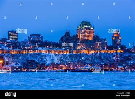 City skyline at twilight, showing Chateau Frontenac in winter, as seen from across the Saint ...