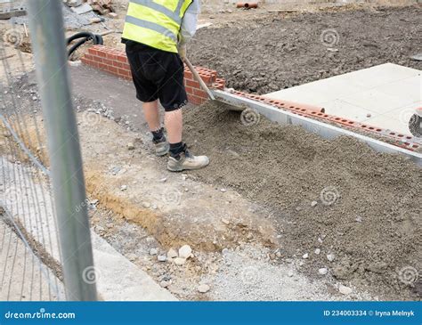 Installation of Edging Pin Kerb on Semi-dry Concrete during Footpath Construction on New Housing ...