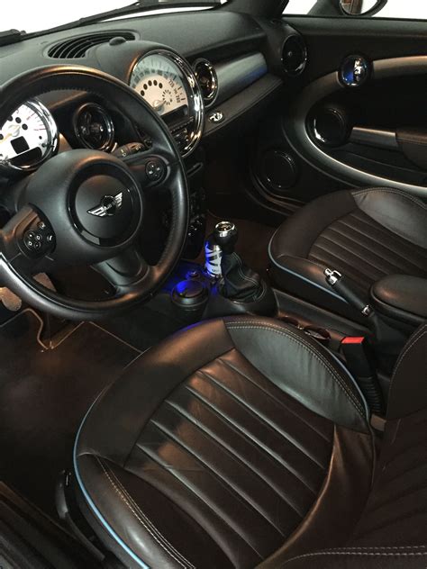 the interior of a car with black leather seats and steering wheel covers, including an automatic ...