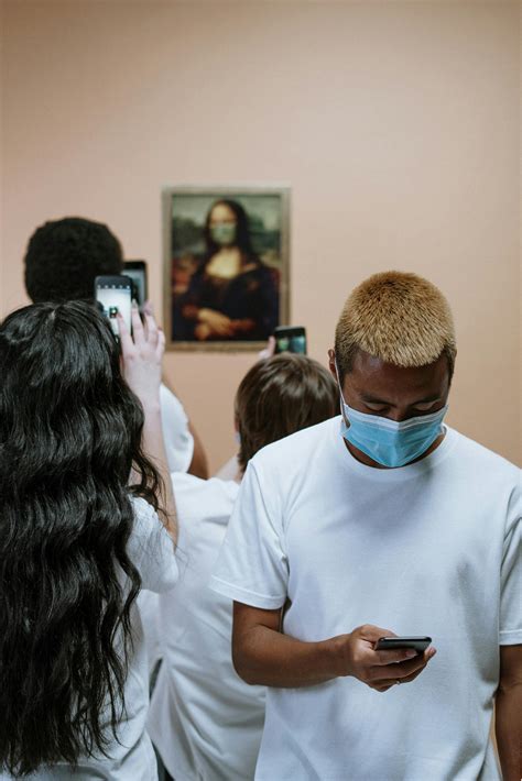 Group Of People Looking At A Painting Of Mona Lisa With Face Mask · Free Stock Photo