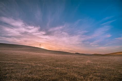 a countryside field during a pink and blue sunset, countryside sunset ...