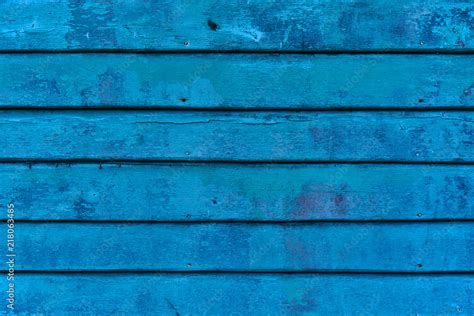 Blue faded painted wooden texture, background and wallpaper. The old blue wood texture with ...