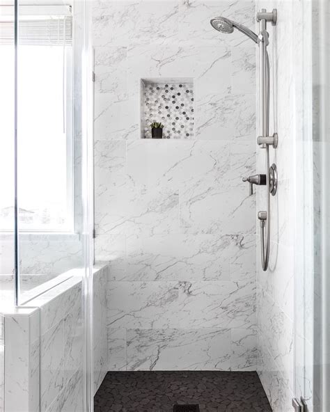 Marble shower with black tile floors - sleek light and bright bathroom design