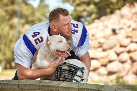 American Football Player with a Dog Posing on Camera in a Park. Copy Space, Sports Banner Stock ...