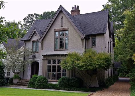 Tudor-Revival Home with painted brick, arched limestone entry and timber detailing. | Tudor ...