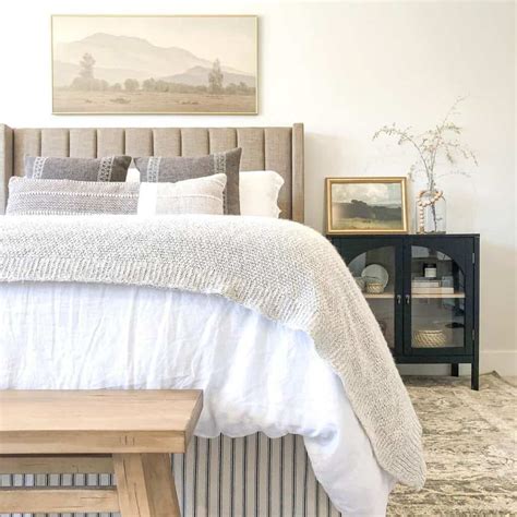 A Landscape Over a Beige Headboard - Soul & Lane