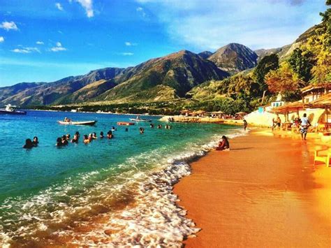 the beach is crowded with people and boats