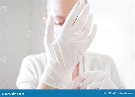 Hand with a Medical Face Mask and Medical Gloves for Protection Against Coronavirus Covid-19 ...