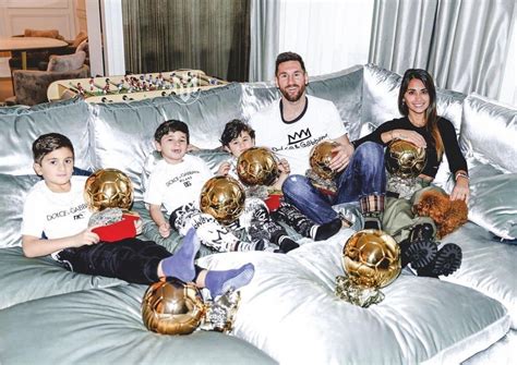 Lionel Messi and his family pose with his seven Ballon d'Or awards in ...