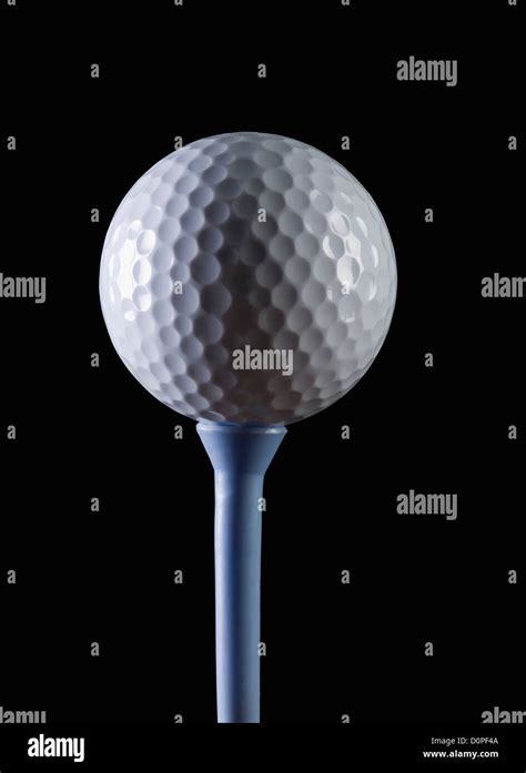 Close-up of a golf ball on a tee Stock Photo - Alamy