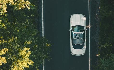 Premium Photo | Aerial view of white convertible car on a road