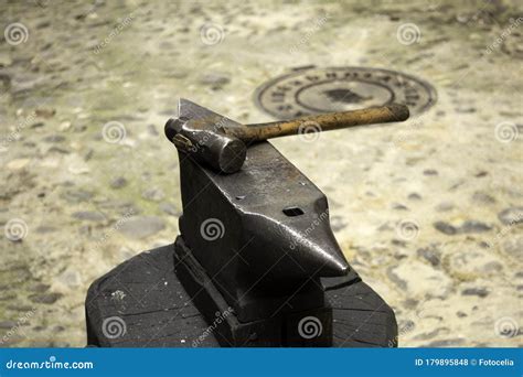 Anvil and forging hammer stock photo. Image of hand - 179895848