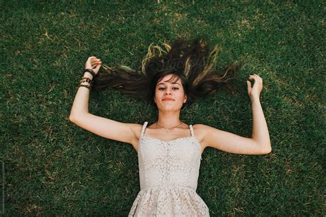 "Teenage Girl Laying In Grass" by Stocksy Contributor "Michelle Edmonds" - Stocksy