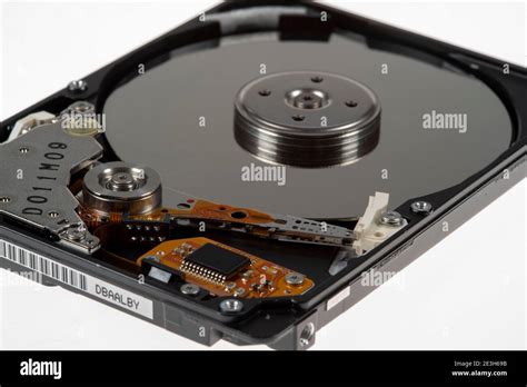 Computer hard disk, opened, read-write head on the storage disk. Symbol image Stock Photo - Alamy