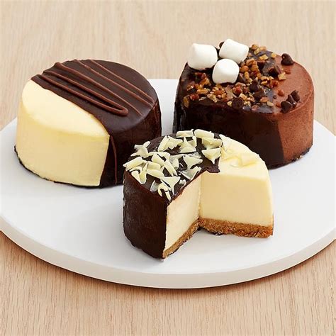 A trio of mini cheesecakes dipped in dark chocolate. Description from ...