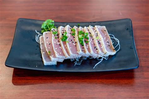 HAMACHI Tataki Served in a Dish Isolated on Wooden Background Side View ...