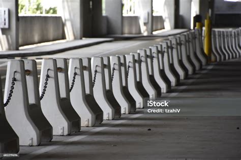 Concrete Barriers In A Parking Lot Stock Photo - Download Image Now - Bollard, Boundary ...