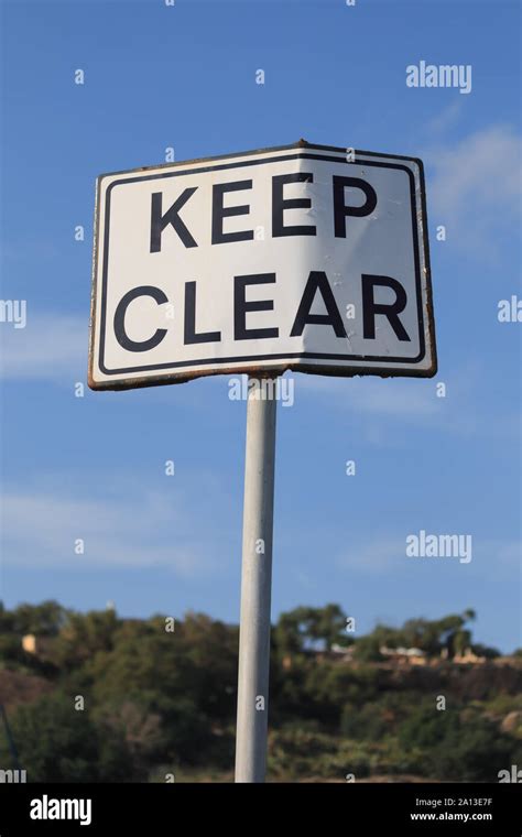 Keep clear road sign in blue sky background, vertical Stock Photo - Alamy