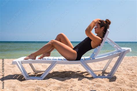 Beautiful girl lying on the beach chair Stock Photo | Adobe Stock