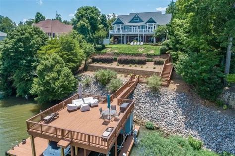 an aerial view of a house on the water with a dock and deck in front