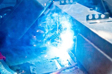 Premium Photo | Cropped image of welder welding metal