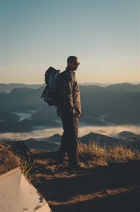 Person Standing on a Cliff · Free Stock Photo