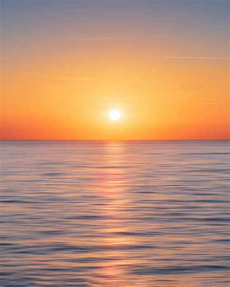 Calm Water With Sun and Orange Sky · Free Stock Photo