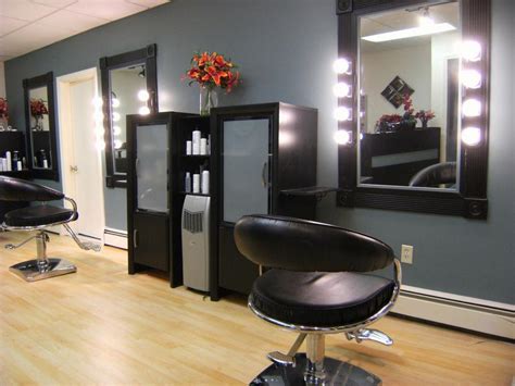 a hair salon with chairs, mirrors and lights