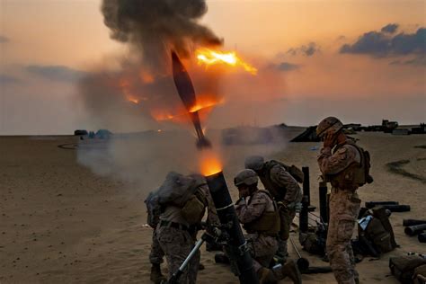 U.S. Marines fire a 120 mm mortar round during a live-fire training in Kuwait, Nov. 17, 2020 ...